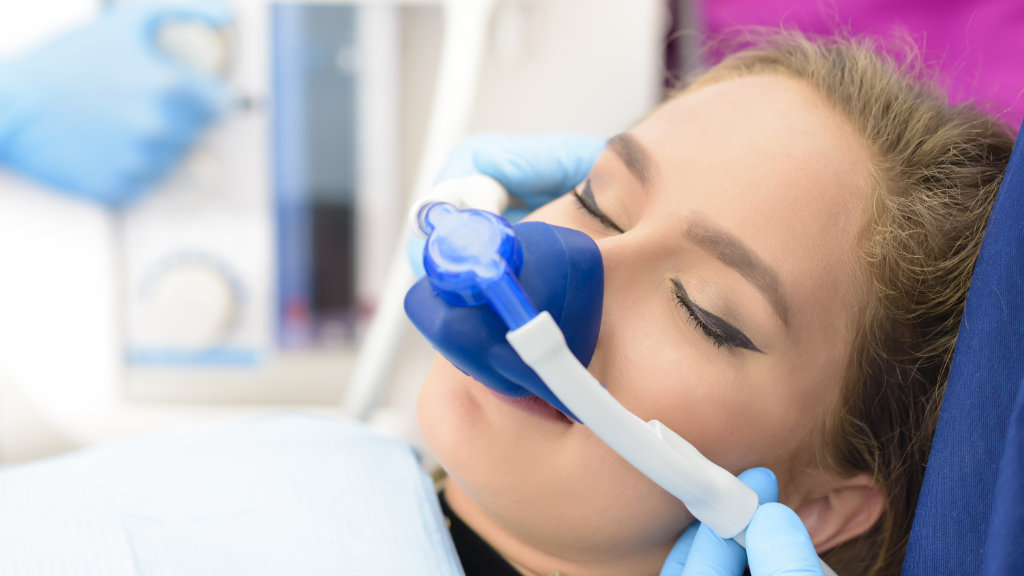 Female dental patient undergoing sedation