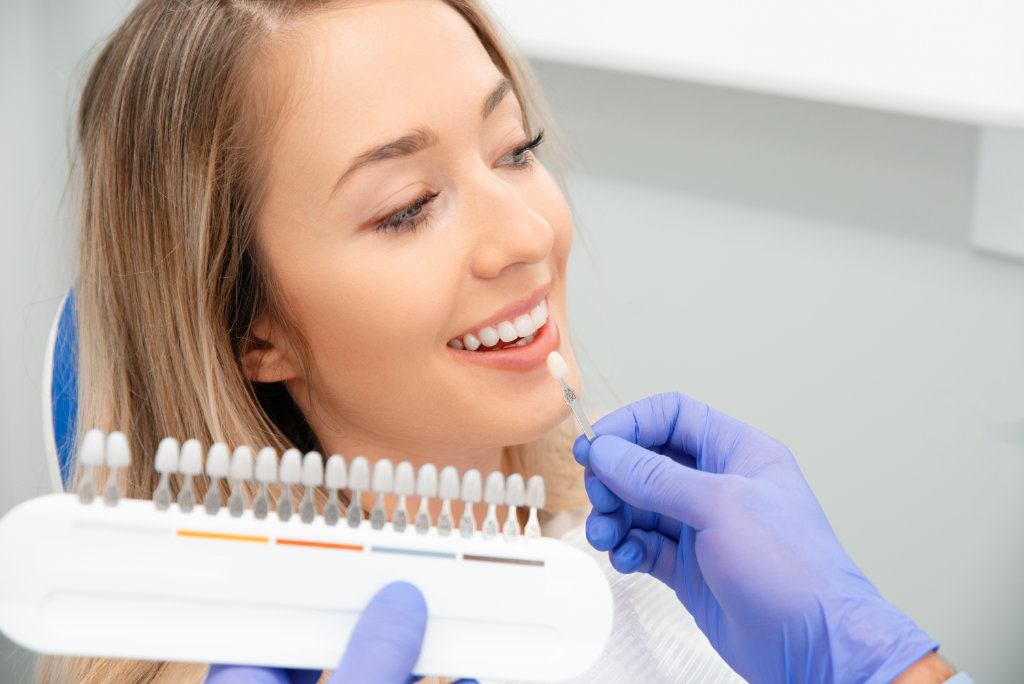 Woman selecting dental veneers at her consultation